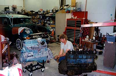 Curtis Welch works on the new engine as the old has just been removed