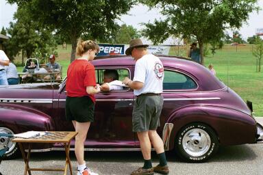 A cruiser gets attention in the poker run registration lane.